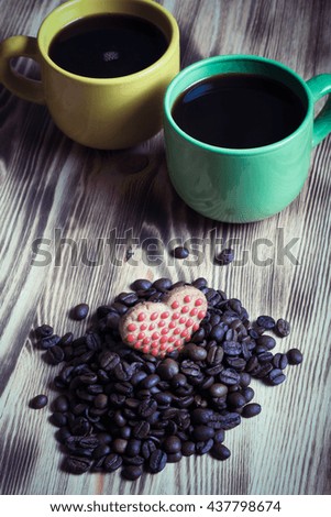Cup of coffee and coffee beans on wooden table for background. Selective focus. Toned.