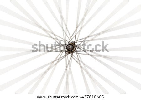 Old wheel of bicycle spoke detail isolated background.Used motion blurr for simulated motion wheel. Royalty-Free Stock Photo #437810605