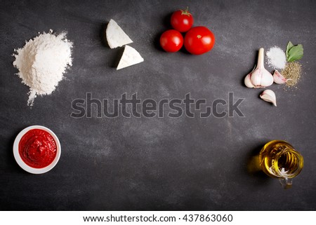 Raw pizza ingredients on the chalkboard with copy space on the center. You can put your image or inscription at the center Royalty-Free Stock Photo #437863060