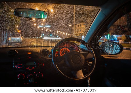 Rain drops on the window's car with traffic blur,Vintage tone
