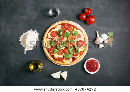 Pizza (margherita) and ingredients on the black chalkboard  Royalty-Free Stock Photo #437874292