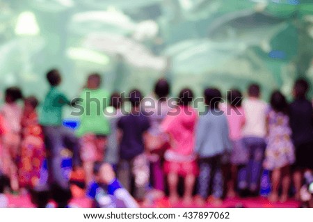 blur image of day Children watching fish feeding at the zoo .