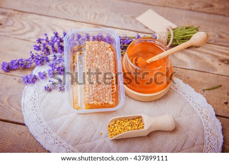 honey, pollen, lavender on a wooden background