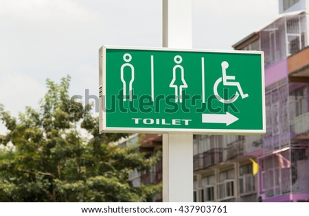 men women and Handicap toilet sign, green light box sign on white pole 