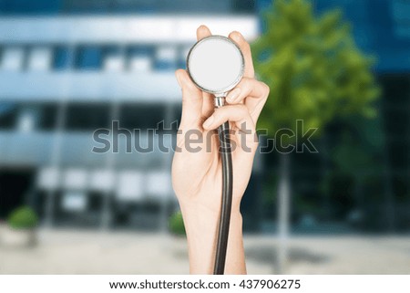 Concept of healing business and economics in the company, stethoscope in female hands as a symbol of the study financial situation.