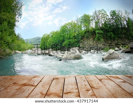 Empty wooden table on waterfall background. Space for your montage