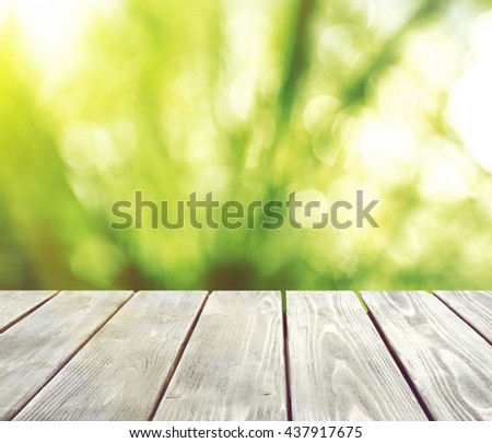 Abstract nature bokeh background and empty wood table