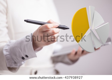 Woman shows a pie chart, circle diagram. Business analytics concept. Royalty-Free Stock Photo #437938927