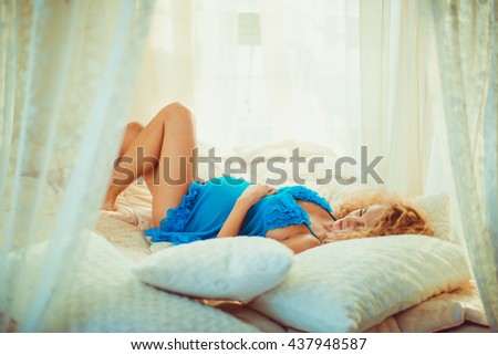 charming pregnant woman sleeping in her bedroom
