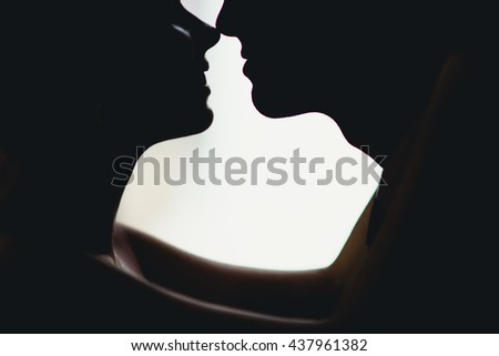 Romantic couple silhouette near the window Royalty-Free Stock Photo #437961382