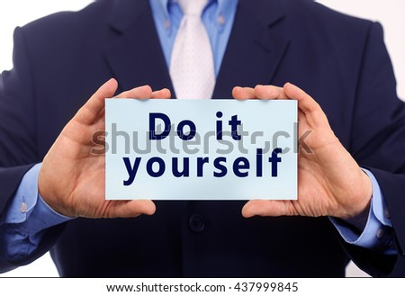 Business man hold paper do it yourself text on it Royalty-Free Stock Photo #437999845