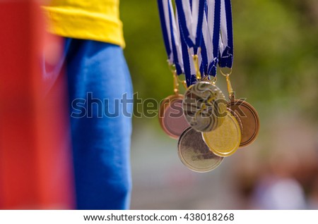 Gold, silver and bronze with symbol of running athlete. Nice wallpaper for summer olympic game in Rio Royalty-Free Stock Photo #438018268