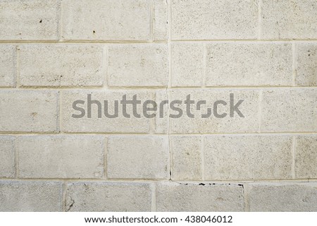 Dirty Pale Yellow Exterior Wall of Concrete Blocks  