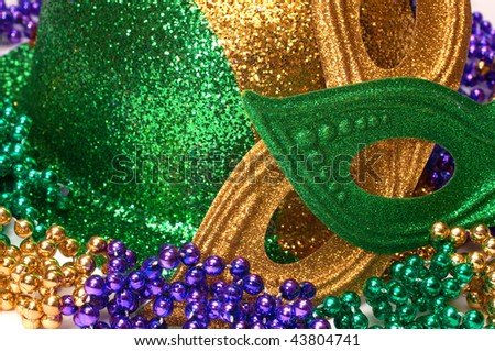 Closeup of Mardi Gras masks, hat, and beads.