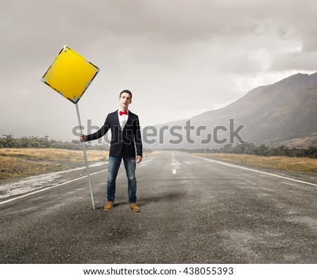 Guy showing roadsign