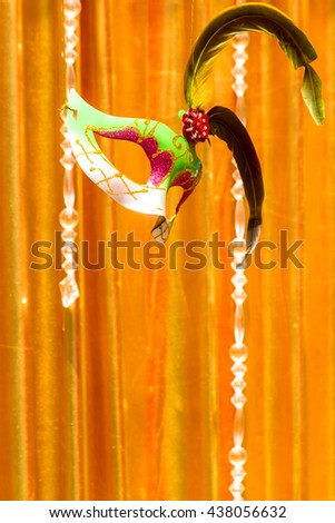 Mask floating on stage and gold curtain background and copy space./ Classical mask  floating on stage of life.