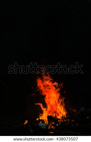 Flames in a bonfire on black background