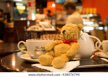 Bear is drinking coffee in coffee shop