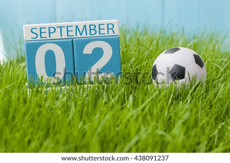 September 2nd. Image of september 2 color calendar on green grass lawn background. Autumn day. Empty space for text