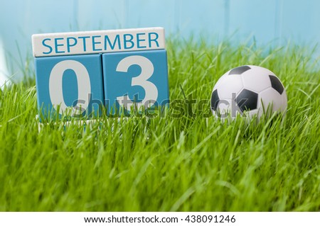 September 3rd. Image of september 3 wooden color calendar on green grass lawn background. Autumn day. Empty space for text