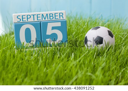 September 5th. Image of september 5 wooden color calendar on green grass lawn background. Autumn day. Empty space for text