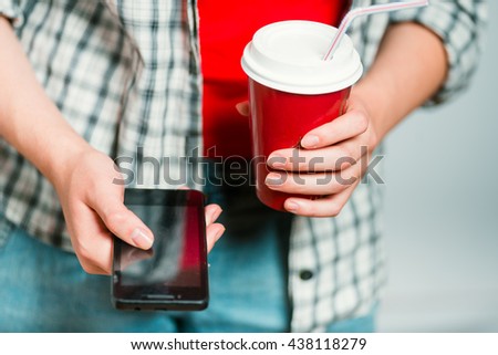 business concept - coffee and a smartphone in the hands, lifestyle