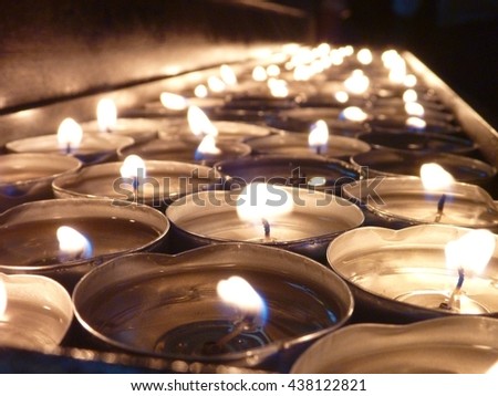 many small candles lightened in a church