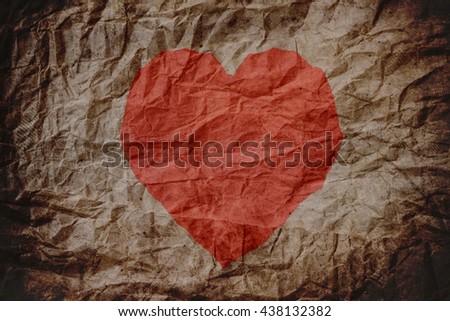 Red heart shape on old crumpled paper texture, heart background, crumpled texture