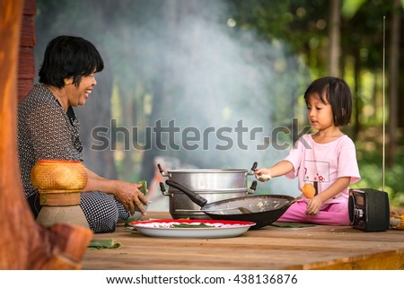 Grandmother and granddaughter making sweets,making ancient thai sweets.