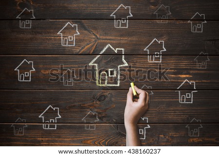 House Drawing on wooden boards. Drawing with chalk.
