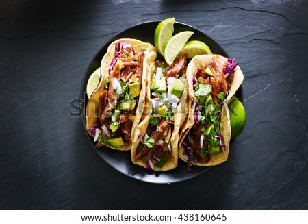 mexican street tacos flat lay composition with pork carnitas, avocado, onion, cilantro, and red cabbage Royalty-Free Stock Photo #438160645