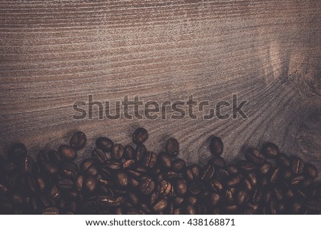 roasted coffee beans on the brown wooden background