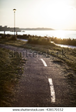 Soft focus image of a cycling track at sunset