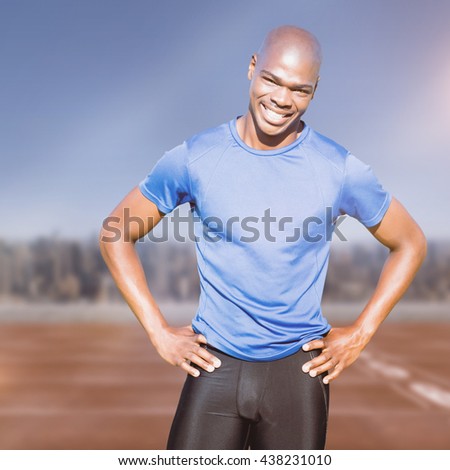Sportsman smiling and posing on a white background against athletic track on a cityscape