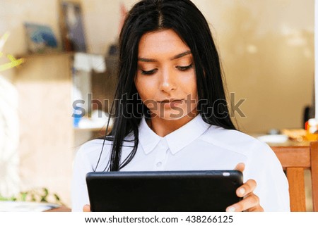 Businesswoman holding tablet in hands. Toned image
