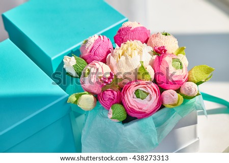 Bright bouquet of paper flowers in turquoise square box