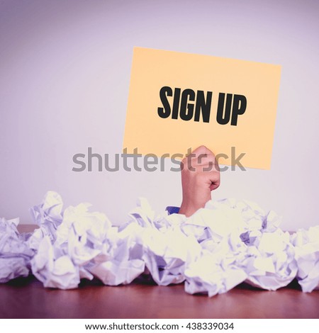 HAND HOLDING YELLOW PAPER WITH SIGN UPCONCEPT