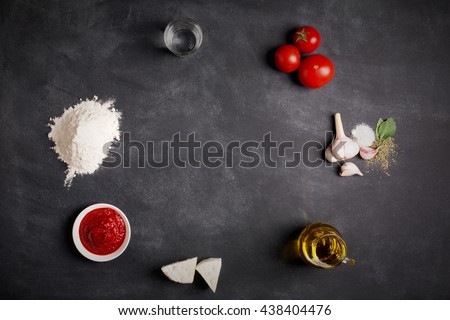 Ingredients for pizza on the chalkboard (tomatoes, cheese, sauce, water, spices, oil and flour) Royalty-Free Stock Photo #438404476