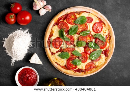 Pizza (margherita) and ingredients on the chalk board (top view) Royalty-Free Stock Photo #438404881