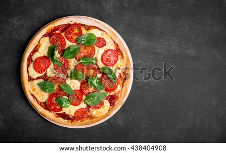 Pizza (margherita) on the chalk board with copy space