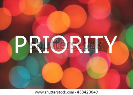 priority word on colorful blurred bokeh background