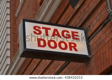 Theatre stage door sign attached to a brick wall above entrance to a theatre
Theatre stage door sign 