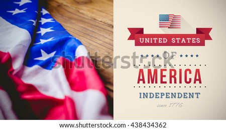 Independence day graphic against usa flag on table