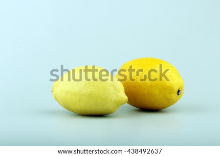 Two ripe yellow lemons in studio