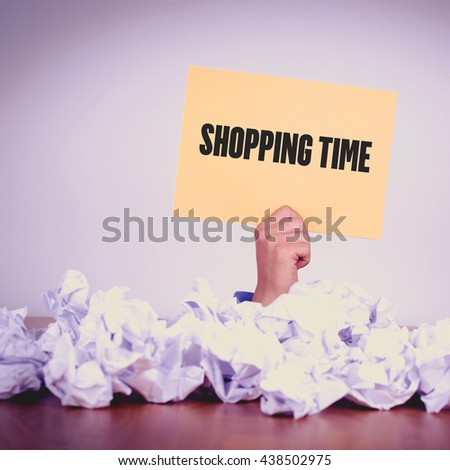 HAND HOLDING YELLOW PAPER WITH SHOPPING TIMECONCEPT