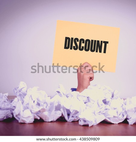 HAND HOLDING YELLOW PAPER WITH DISCOUNTCONCEPT
