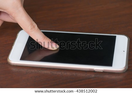 Close up women using smartphone on wood table.