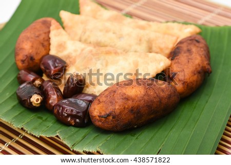 Fried madakku/ chicken pathiri, banana rolls, popular Kerala snack for Ramadan Kareem with dry fruit date. Traditional Iftar food dish Malabar Muslim feast, India. Holy month of Ramzan.