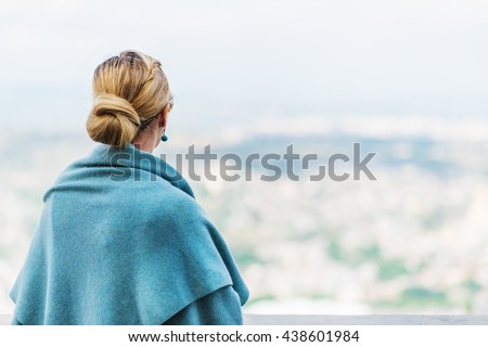 Back view of a woman with tied blond hair looking at the nature background during a nice sunny morning.
 Royalty-Free Stock Photo #438601984