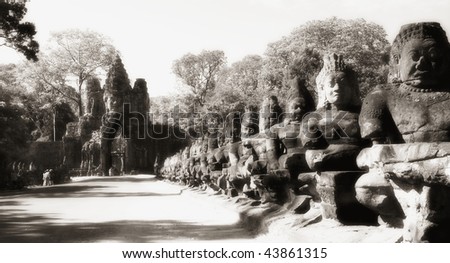 Gate to Angkor Thom lined by row of giant figures (demons), Angkor, Cambodia, infrared monochrome image.